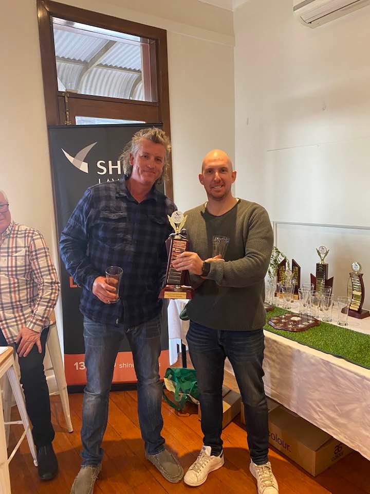 Pete and Egg with a winners cheque